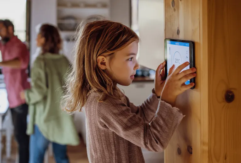 Child using a wall mounted smart home panel